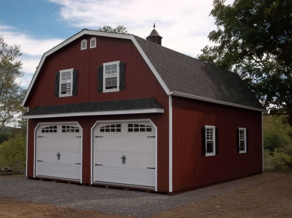 Red 2-story Gambrel garage with loft and space for 2 cars